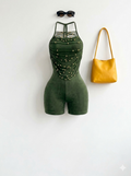 One-piece black strappy bodysuit with gold studs